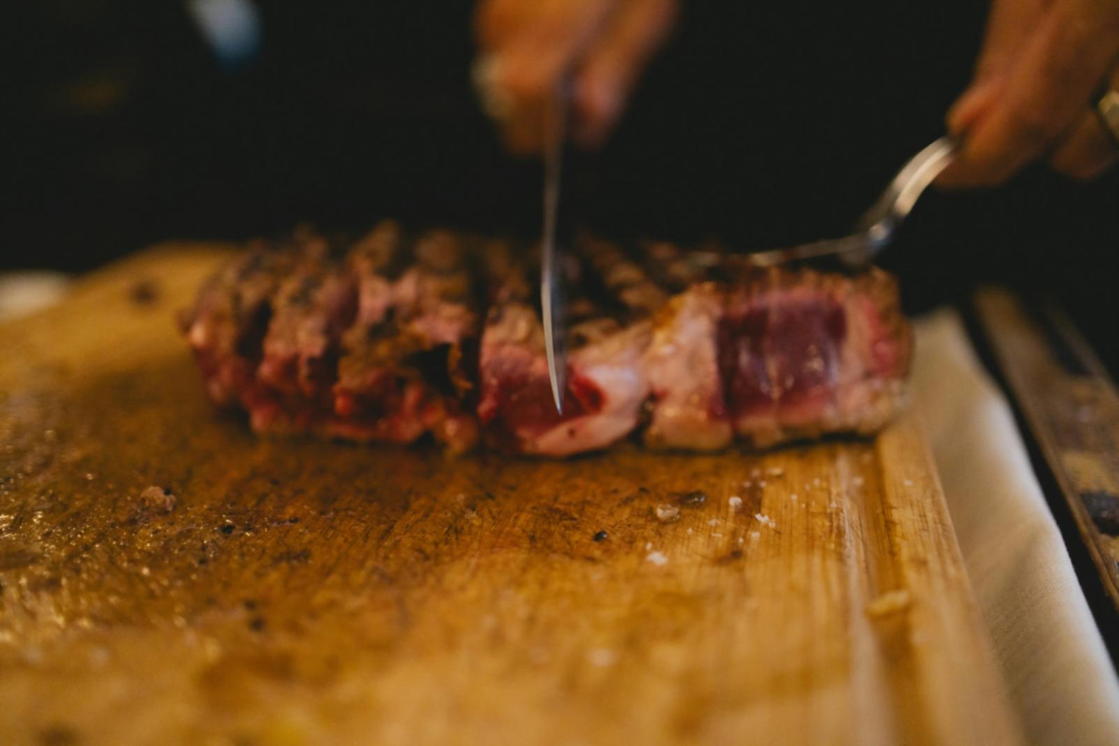 Professional kitchen workspace with fresh ingredients prepared for cooking instruction