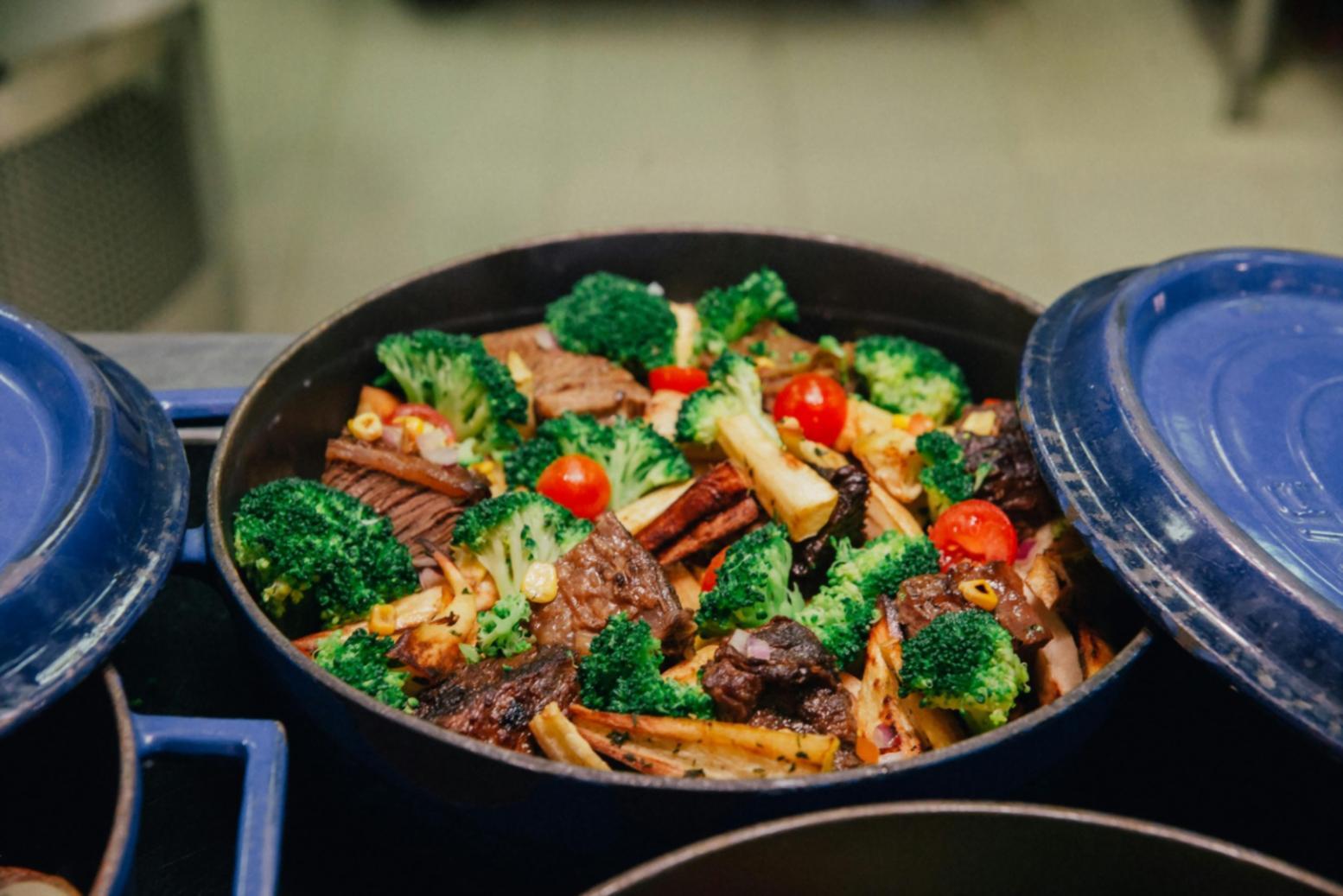 Hands-on culinary instruction showing detailed cooking technique demonstration